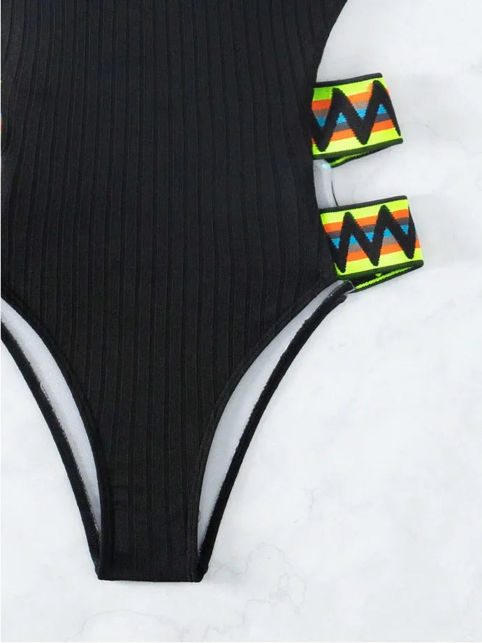 Women's solid black or orange one-piece polyester swimsuit with size guidance