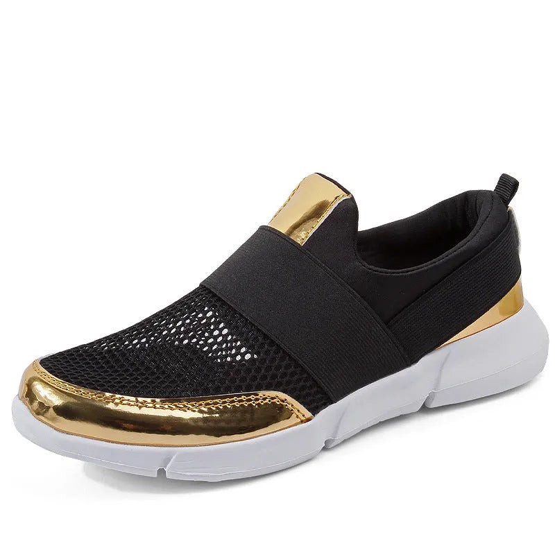 Blue low-top women's mesh sneakers with a casual design on a hard floor surface.