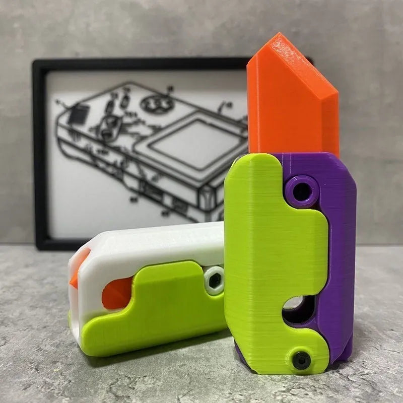 3D printed gravity carrot fidget knife in orange, purple and green colour on white background