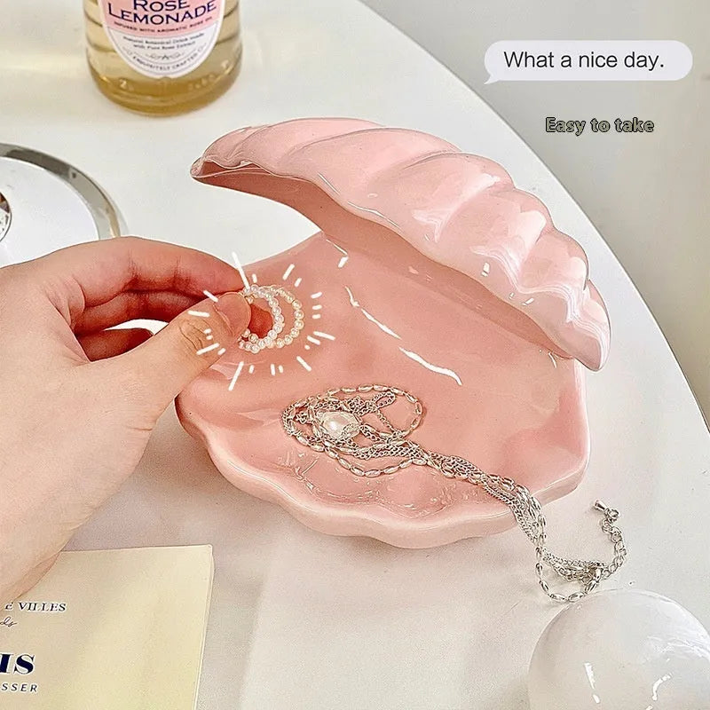 White porcelain girls ornament tray with small night light, shown in yellow and pink shell options.