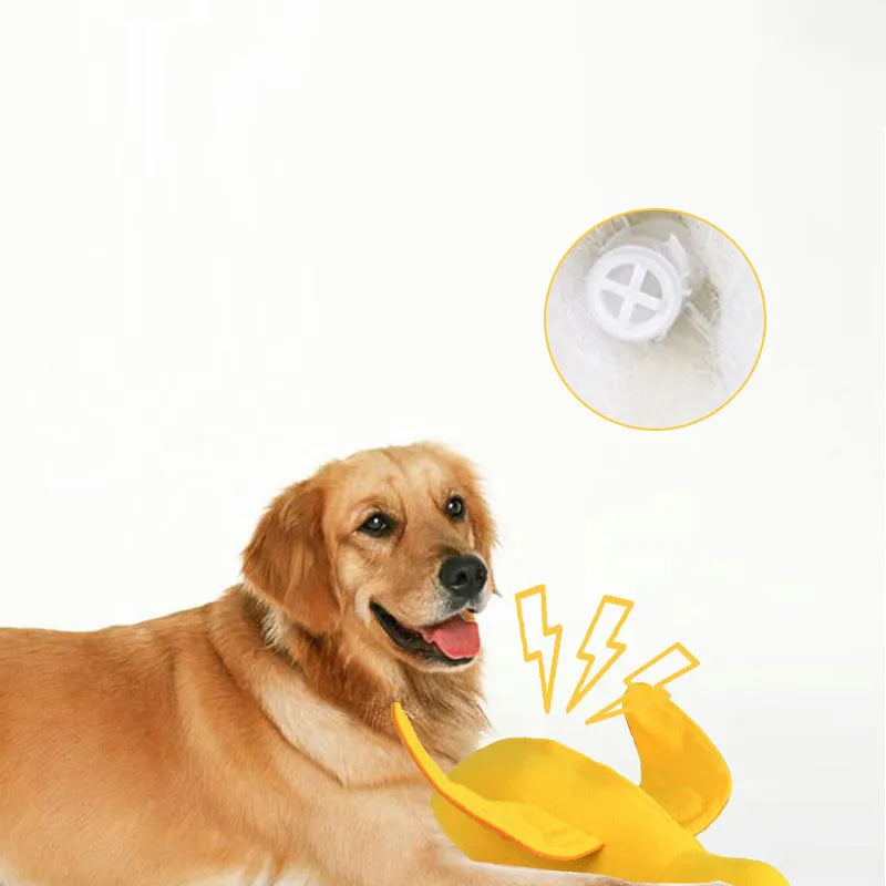 Yellow plush teddy dog toy with a attached duck doll and visible treat pockets on a white background.