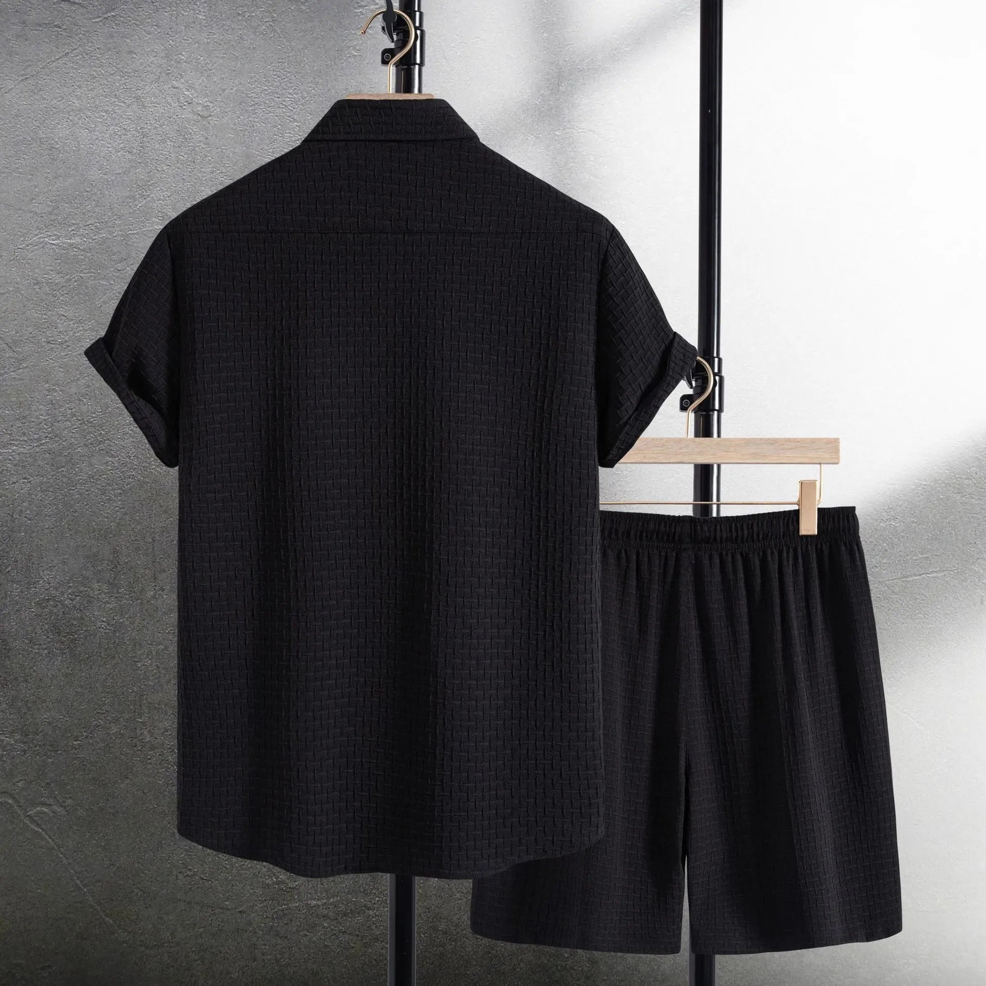 Men's black cotton blend short sleeve shirt and shorts casual summer suit on a hanger.