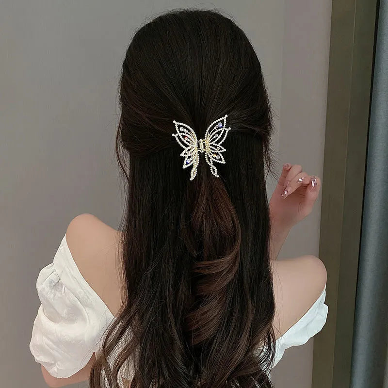 Butterfly-shaped alloy hair barrette for women with pearl or rhinestone decoration, shown from the front.