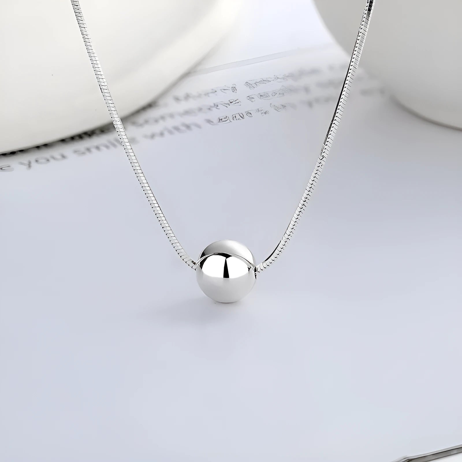 925 sterling silver clavicle chain necklace with round ball pendant on woman's neck