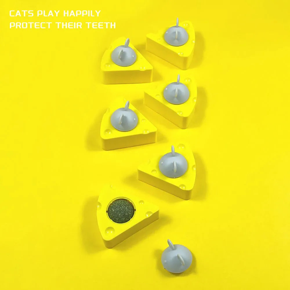Yellow catnip and silvervine chew ball toy for cats on wooden floor