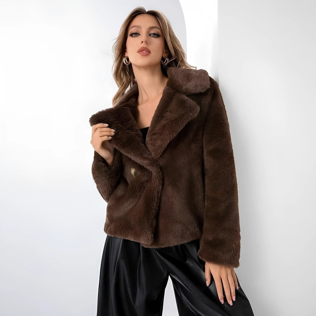 A rose red women's short loose faux fur coat with regular sleeves on a model.