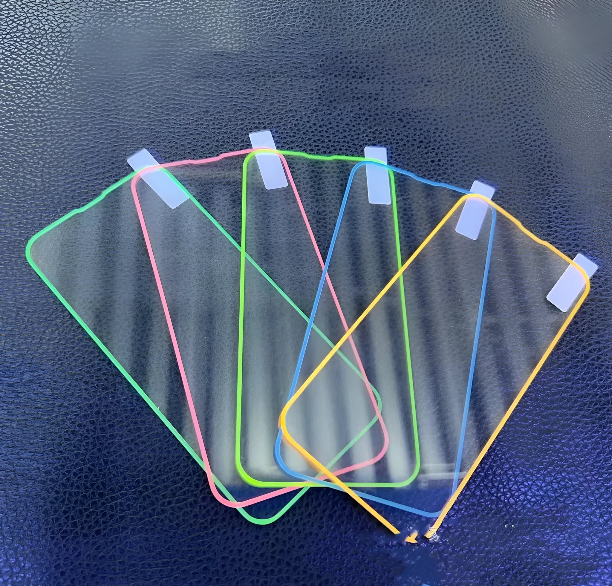 Fluorescent tempered glass screen protector for iPhone showing pink yellow green blue grass green colour options