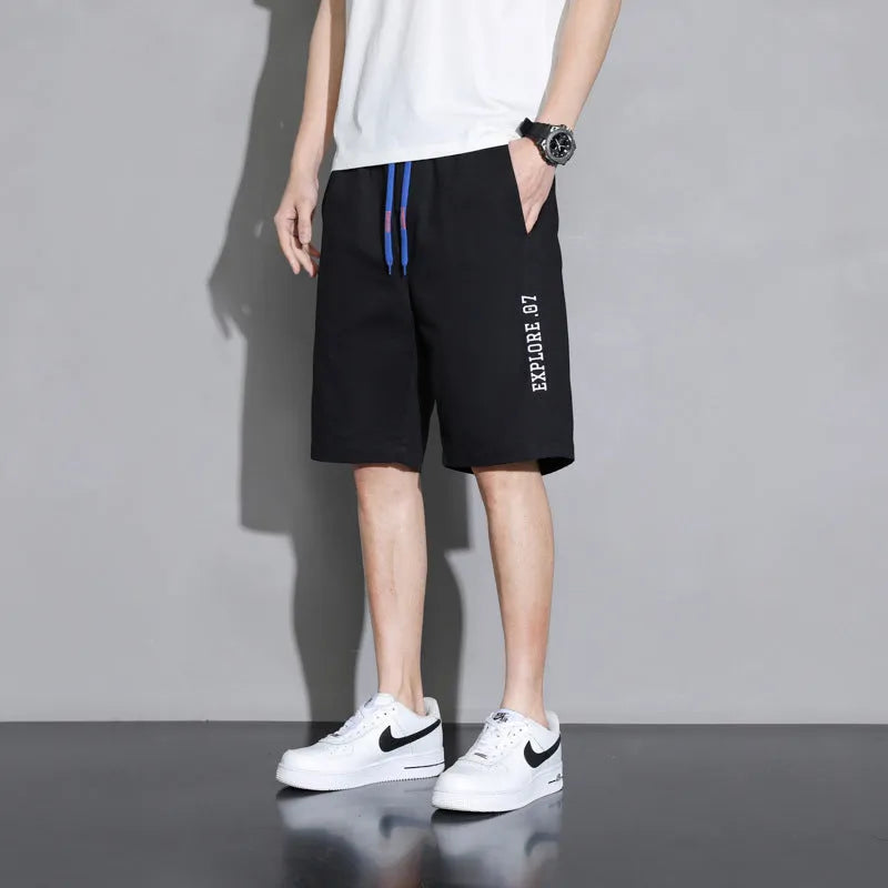Boys' plus size cotton shorts in black, shown flat, featuring a mid waist and shorts length design.