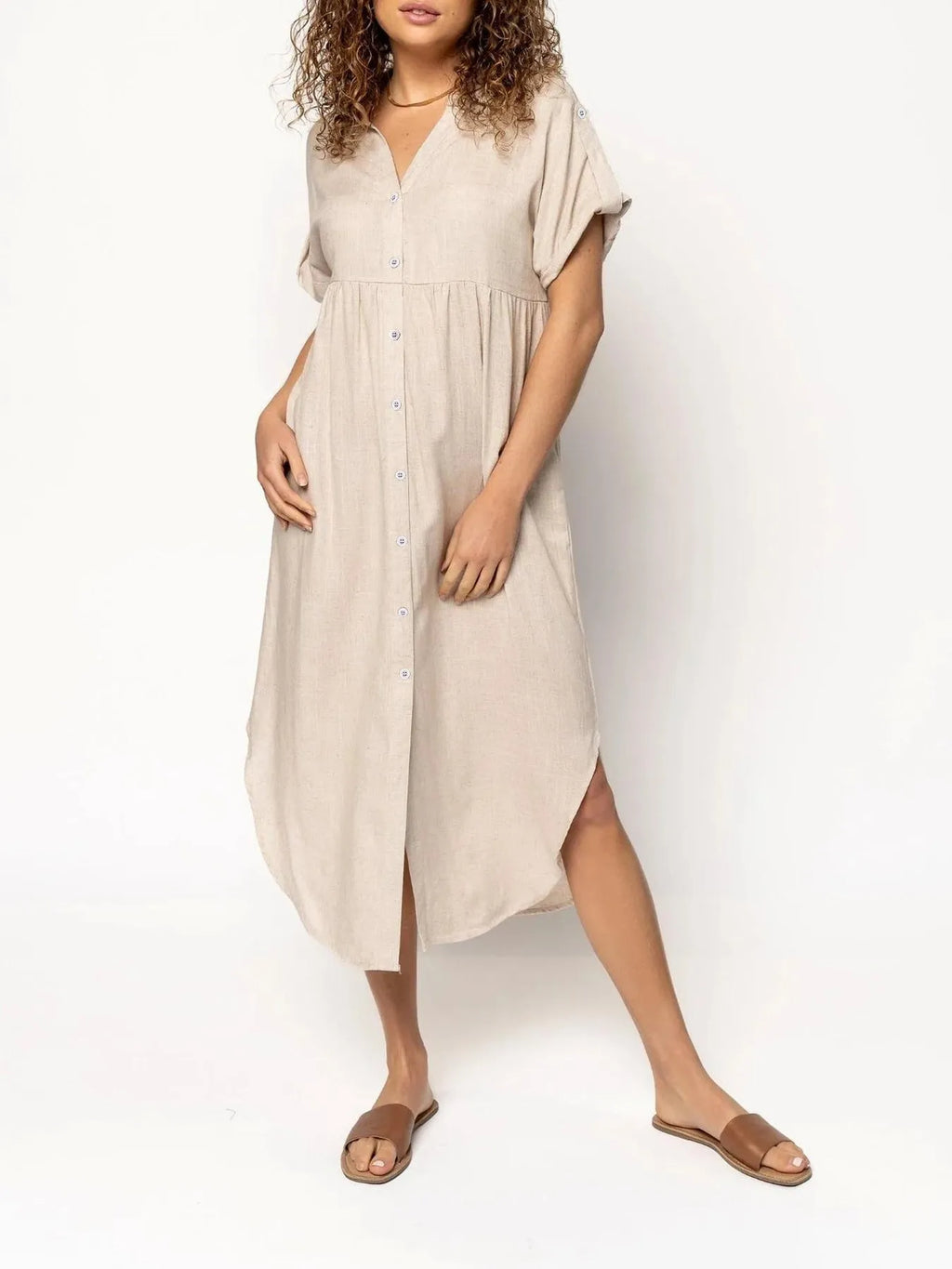 A loose-fitting, solid-colour button-down midi dress on a hanger, shown in apricot colour.