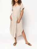 A loose-fitting, solid-colour button-down midi dress on a hanger, shown in apricot colour.