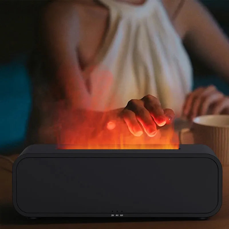 Black aroma diffuser with glowing orange flame effect and colour-changing LED base on a wooden table