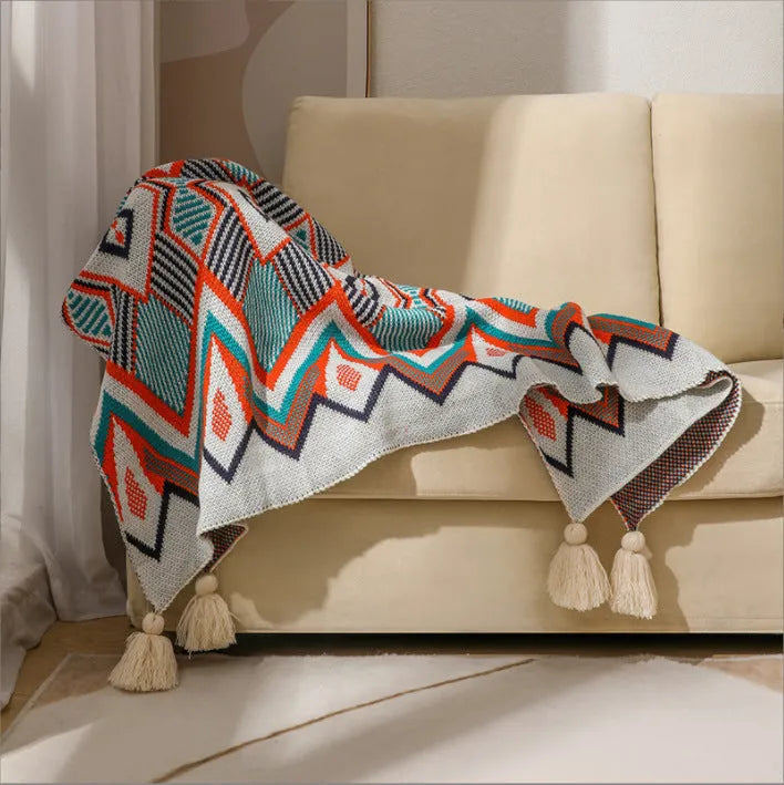 Bohemian style acrylic sofa throw blanket with tassel trim in a geometric pattern colour