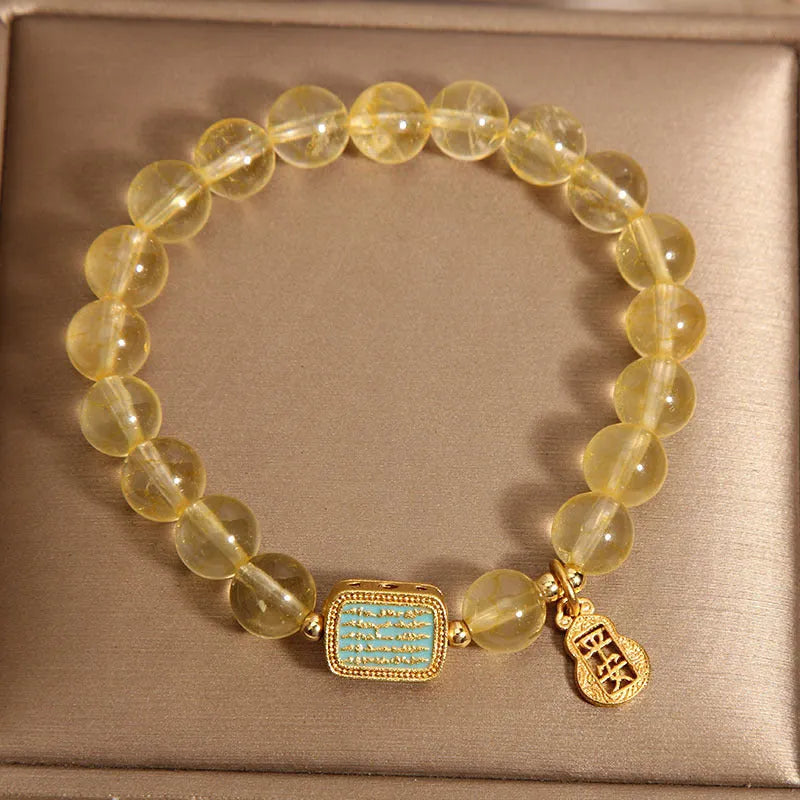 Women's natural yellow crystal bracelet with citrine colour round beads and rhinestone accents, sliding knot closure