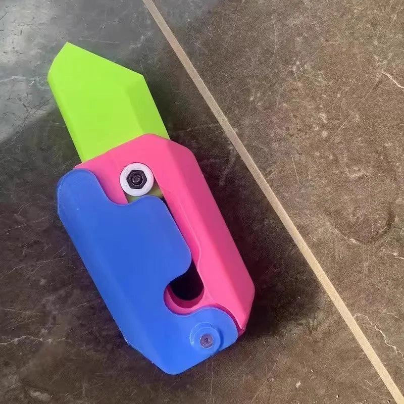 3D printed gravity carrot fidget knife in orange, purple and green colour on white background