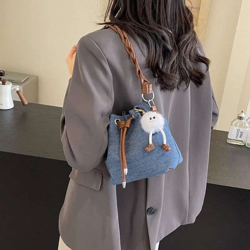 Blue synthetic leather cross body bucket bag with one-shoulder strap and sandwich pocket design