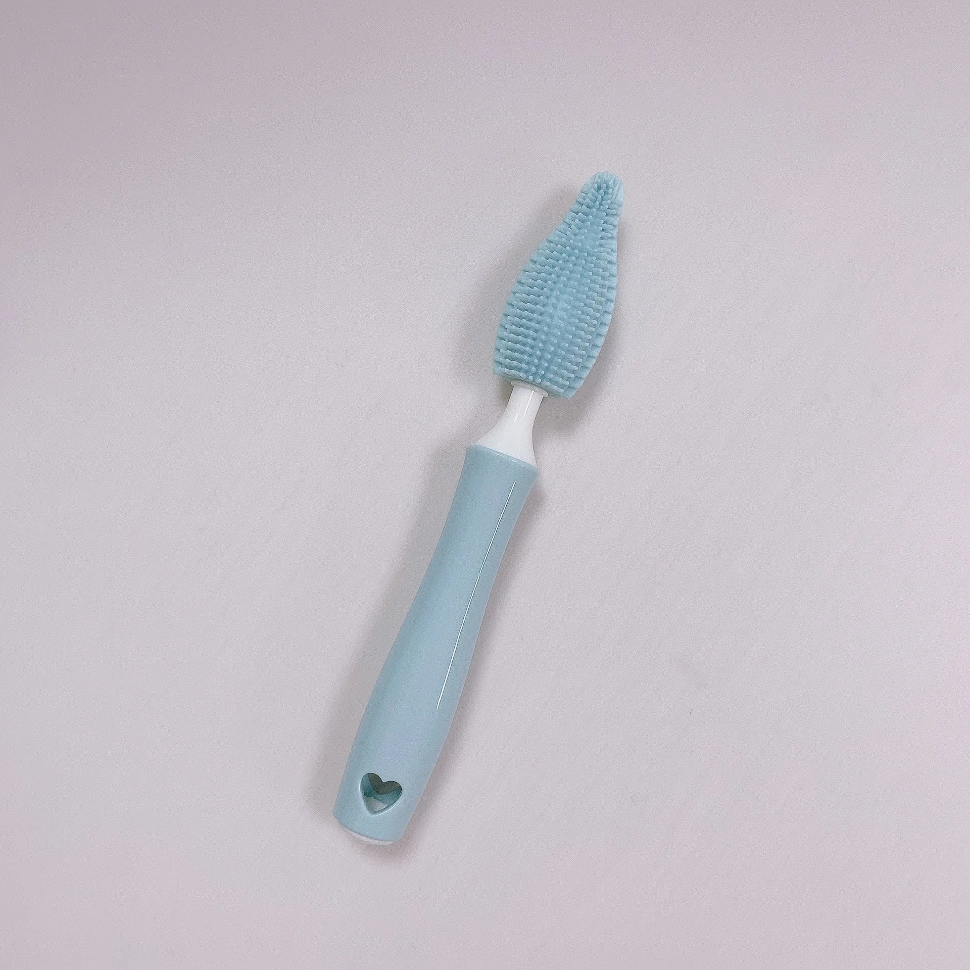 Three-piece silicone baby bottle brush set in pink, blue, and yellow with straw cleaning tool