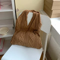 Retro hollow knitted wool yarn women's shoulder tote bag in solid colour showing double straps.