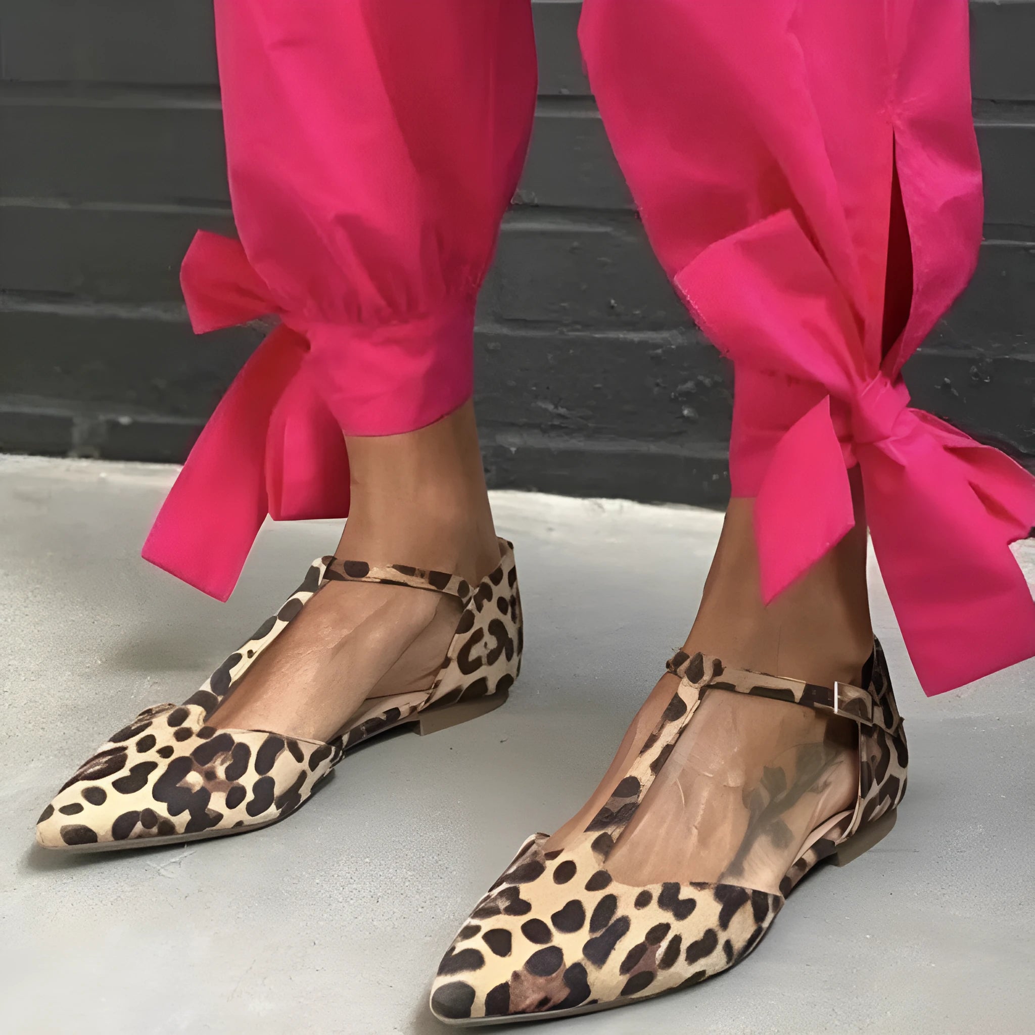 Leopard print women's pumps with pointed toe, low chunky heel, and cross shoulder straps.