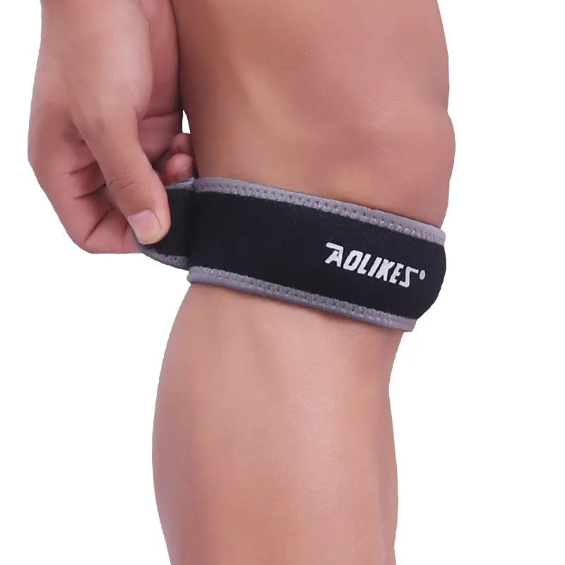 Black and grey patella retinaculum knee pad for outdoor sports protection.