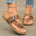 Roman style toe covering leopard slippers with wooden sole on neutral background