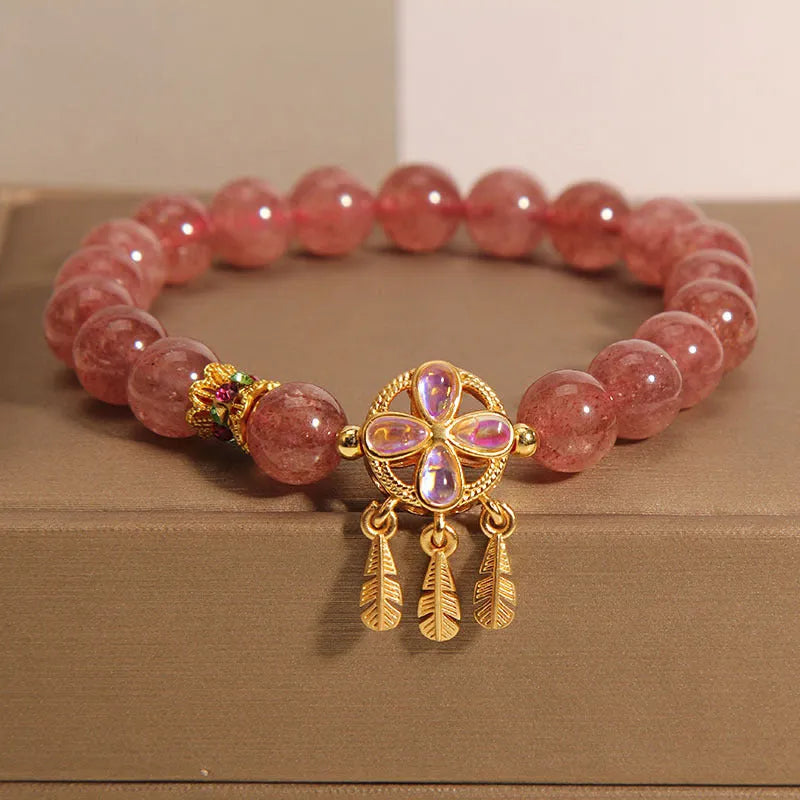 Women's strawberry quartz bracelet with four-leaf clover dream catcher pendant and silver ball charms