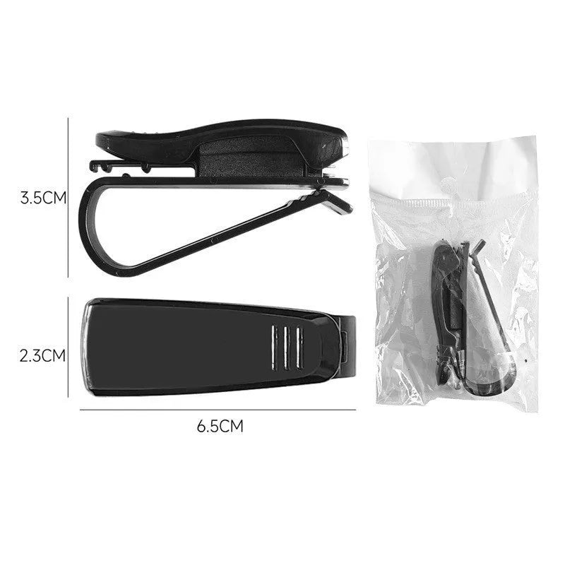 Black plastic clip for car sunshade holding a ticket and glasses