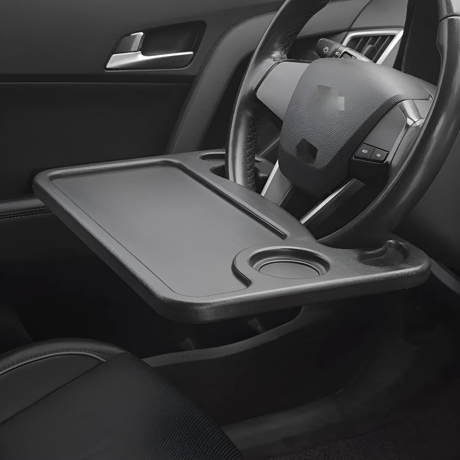 Black plastic car computer desk and dining tray measuring 42 x 28cm on a car seat