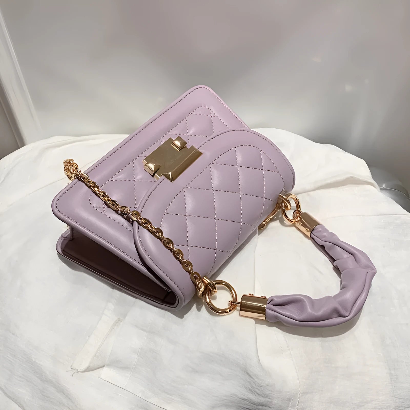 Purple women's small square shoulder bag with crossbody strap showing tapered 16x19cm design