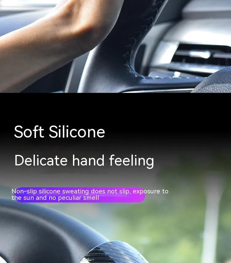 Black silicone steering wheel assist ball with metal bearing on a car steering wheel.