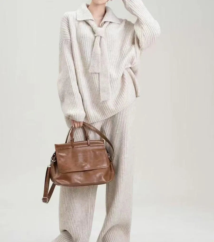 Women's beige imitation cashmere knitted sweater top and matching trousers two-piece set.