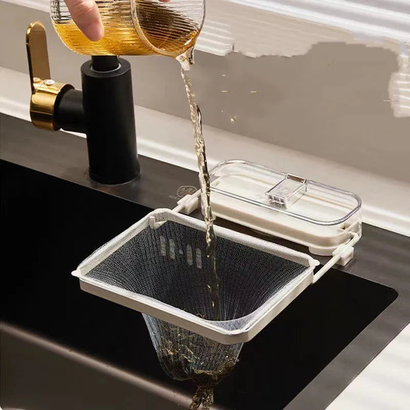 Kitchen sink filter rack with suction cups, fine mesh screen, and disposable filters in dark green gold on a sink drain