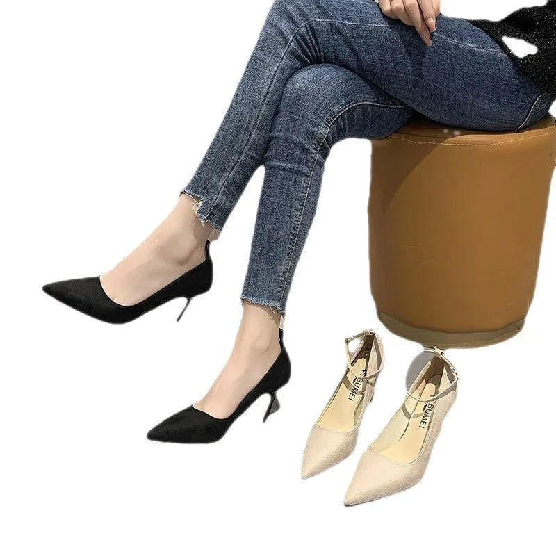 Women's black stiletto heel pump shoes with a buckle detail on the upper.