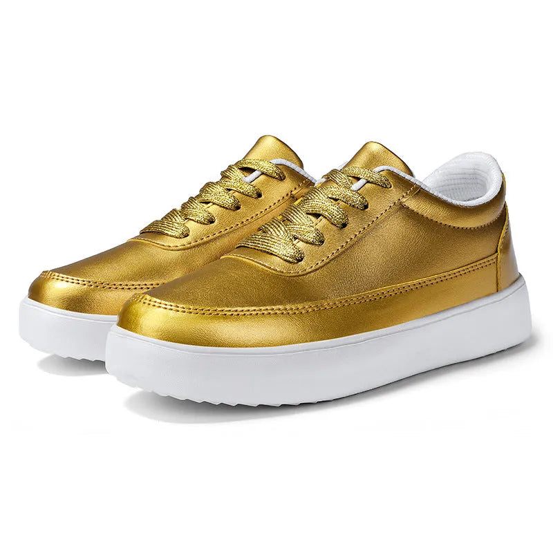 Women's leather flat casual trainers in gold, featuring front lace-up design on a white background.