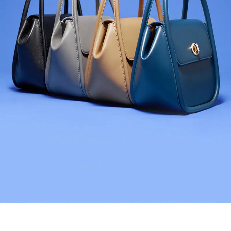Soft wing-shaped leather cross-body tote bag in cow leather with a buckle and latch closure.