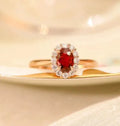 Gold Pigeon red blood gemstone silver-plated ring with floral design on white background