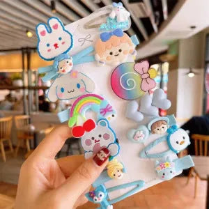 14-piece toddler hair accessories set on display including rainbow barrettes, fruit clips, and butterfly pins in bright colours