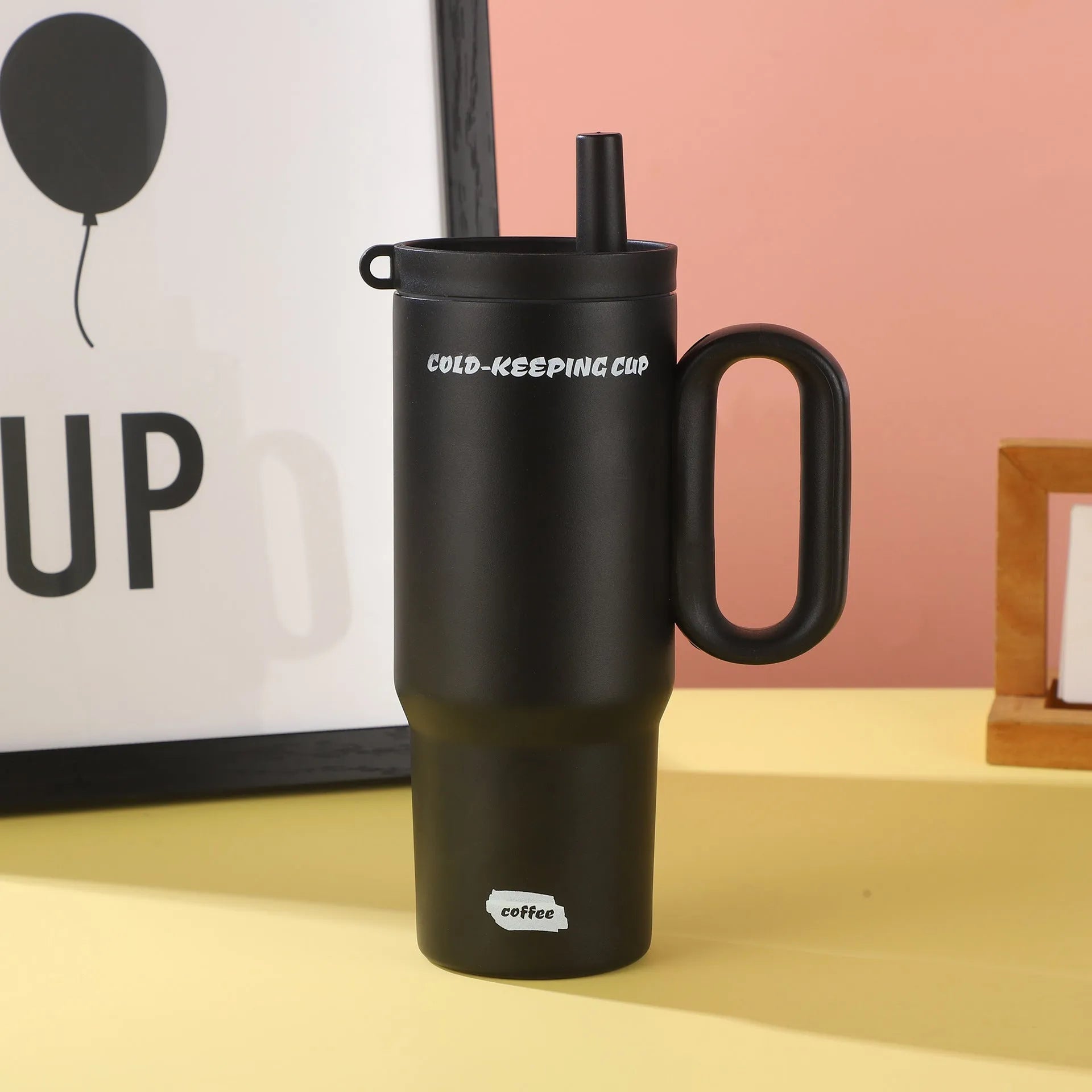 Portable insulated drink cup with carry handle and straw lid in multiple colours