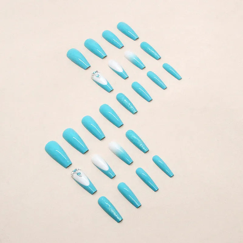 Long ballet-shaped press-on nail patches in solid smart blue diamond colour with glue bottle.