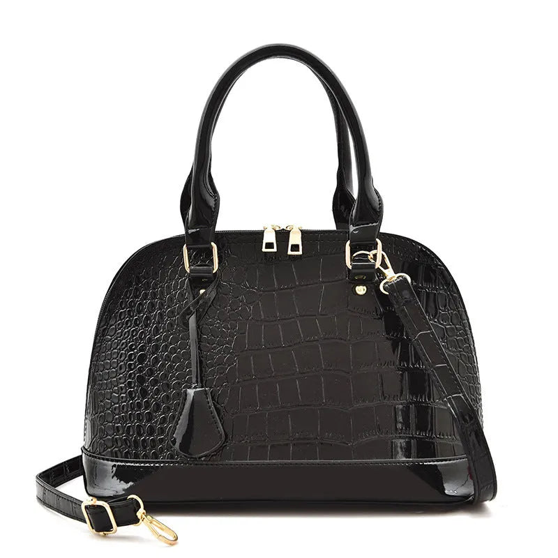 Large shell-shaped shoulder crossbody bag in shiny PU leather with structured silhouette