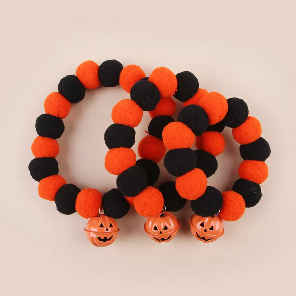 Orange pumpkin Halloween cat collar with green stem on an adjustable strap for pets.