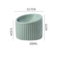 Ceramic raised cat bowl with tilted design in green colour on wooden surface