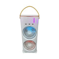 White double-ended spray fan with humidifying mist and remote control on a desk