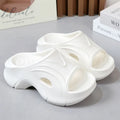 Women's white EVA beach slippers with a thick sole and round toe.