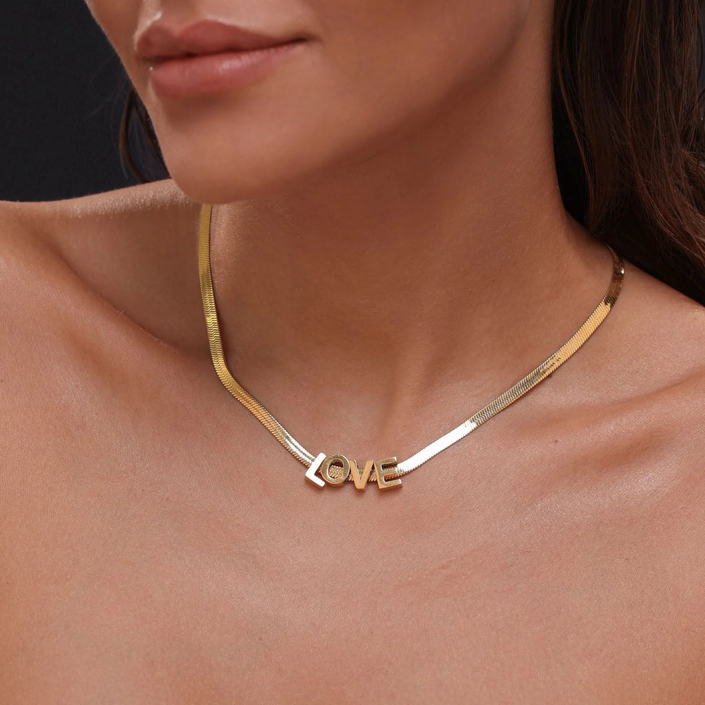 Gold and silver titanium steel necklaces with letter, number, and heart pendants on 40cm chains.