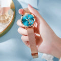 Women's fashion watch with mesh strap and rose shell case showing six colour face options