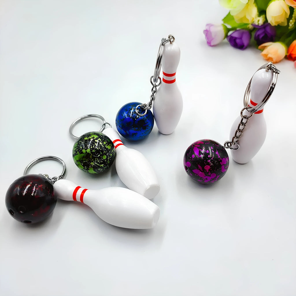 Mini PVC metal bowling ball keychain pendant in blue, dark red, green, or purple.