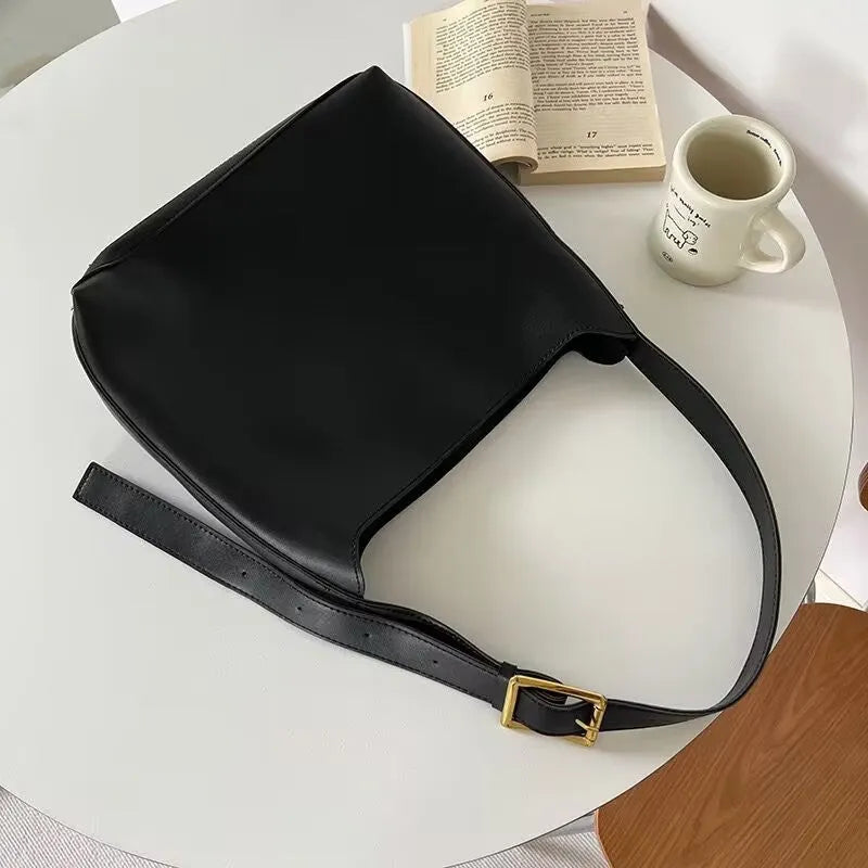 Women's soft PU shoulder bag with swing threads in black ribbon or brown colour options