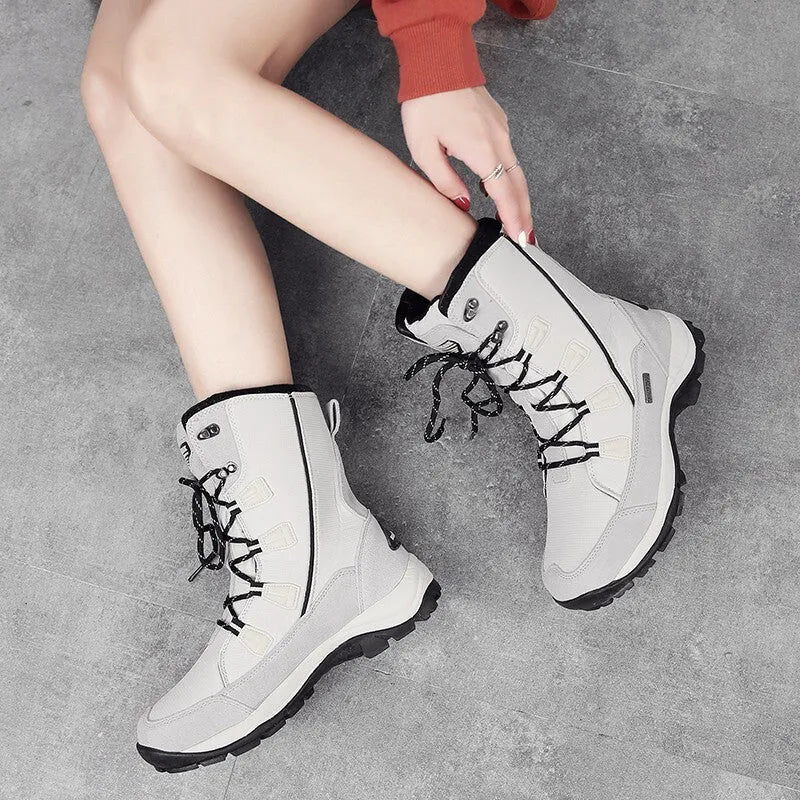 Women's black waterproof thermal snow boots with a genuine leather upper and mid-calf height