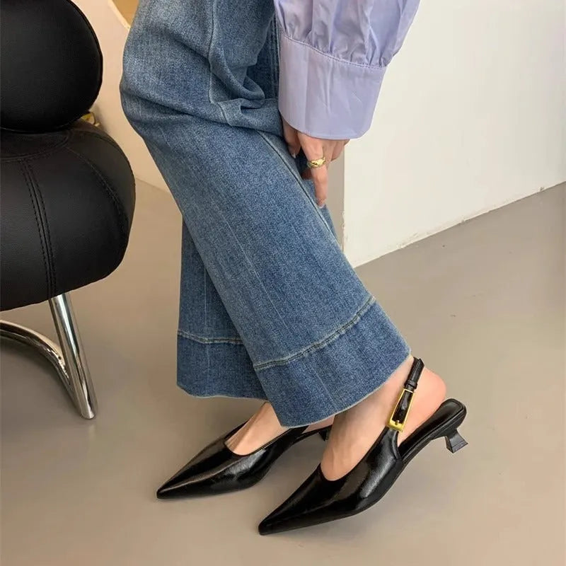 Thin low heel strap pointed leather shoes for women, black colour, side view showing heel height and ankle strap