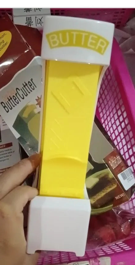 Yellow stick butter cutter cheese slicer one-button dispenser with ABS body and stainless blades on white background